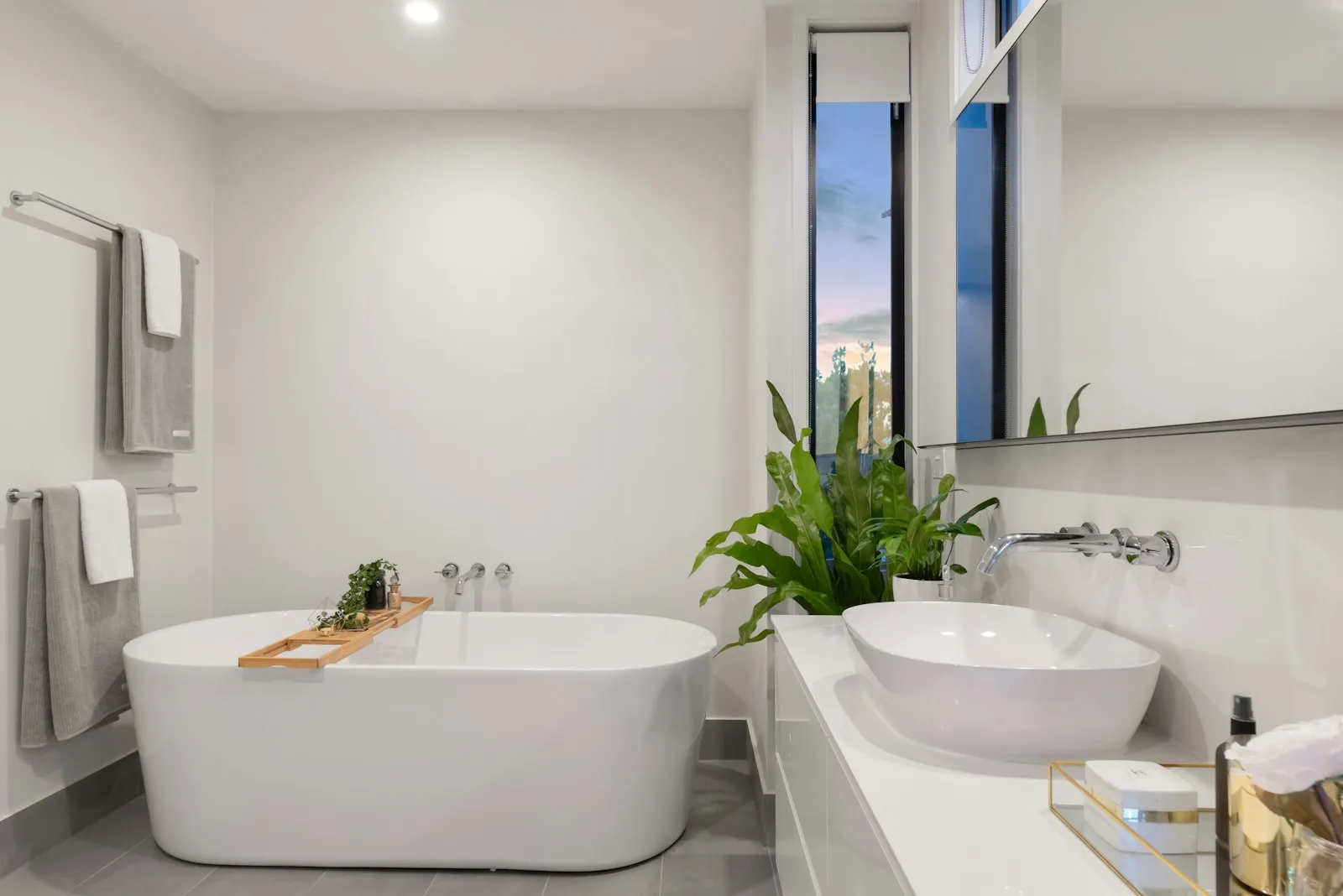 Bathroom with freestanding tub and polished fixtures