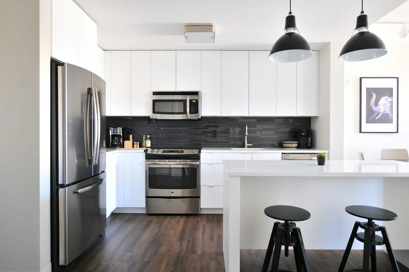 An empty, freshly cleaned kitchen with a white island ready for move-in